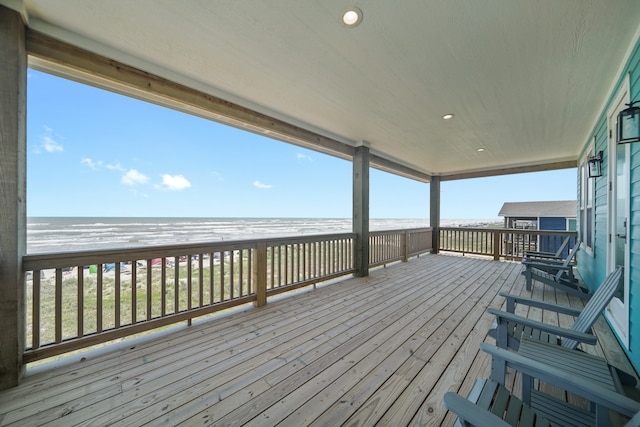 deck with a water view and a beach view