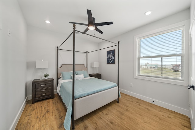 bedroom with light wood-type flooring and ceiling fan