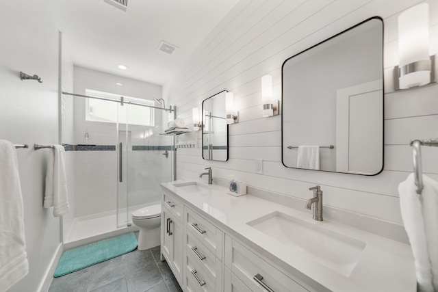 bathroom with wooden walls, vanity, tile patterned floors, a shower with shower door, and toilet