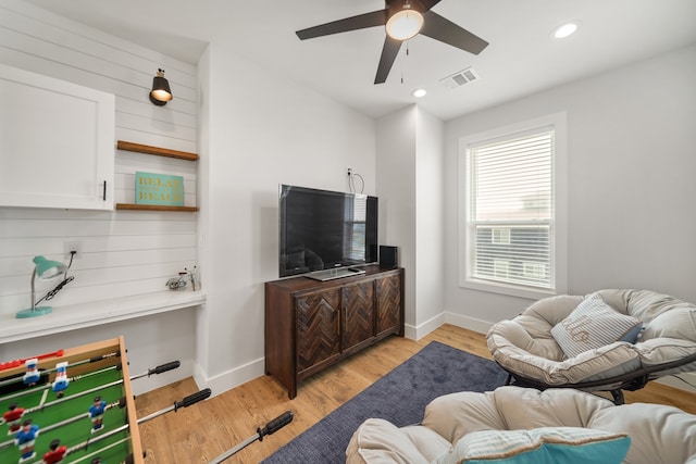 living room with ceiling fan and light hardwood / wood-style floors