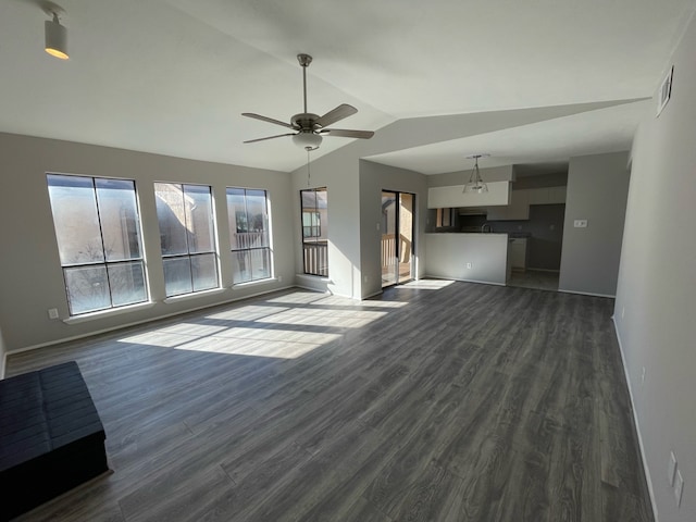 unfurnished living room featuring ceiling fan, dark wood-type flooring, and vaulted ceiling