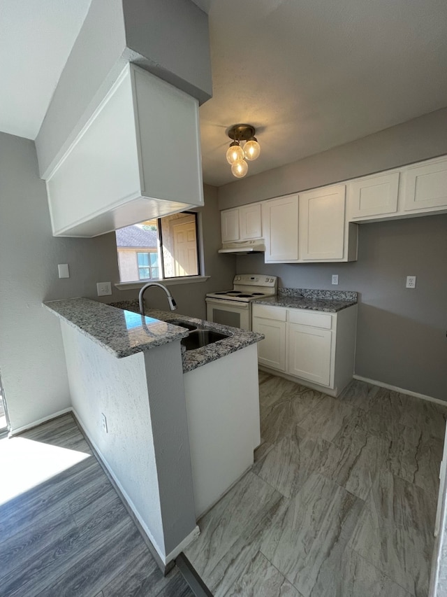 kitchen with white electric range, kitchen peninsula, dark stone countertops, sink, and white cabinets