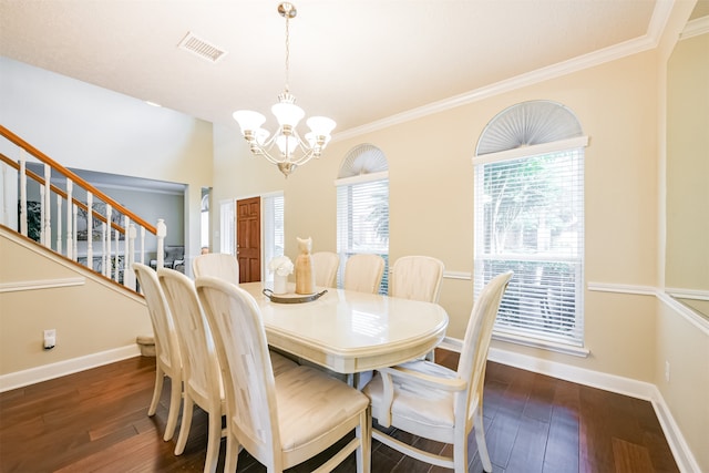 dining space with ornamental molding, dark hardwood / wood-style floors, a chandelier, and a wealth of natural light