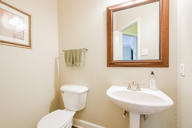 bathroom featuring toilet and sink