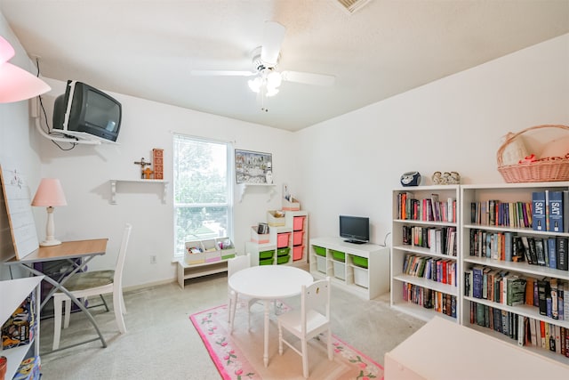 recreation room featuring light colored carpet and ceiling fan