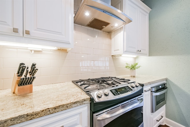 kitchen featuring gas range, white cabinetry, tasteful backsplash, and extractor fan