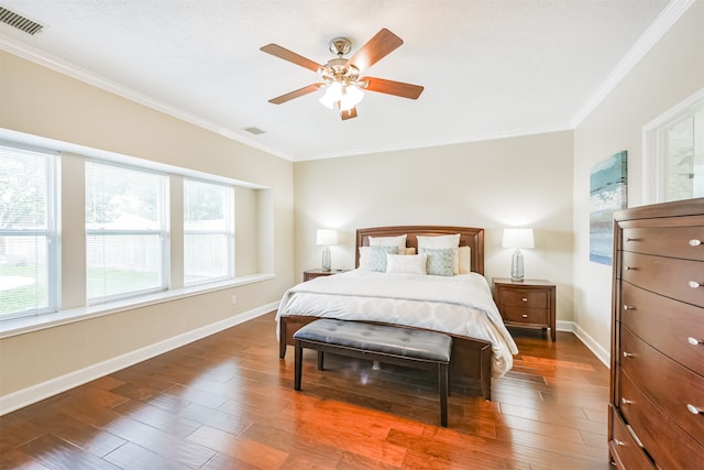 bedroom featuring crown molding, dark wood-type flooring, and ceiling fan