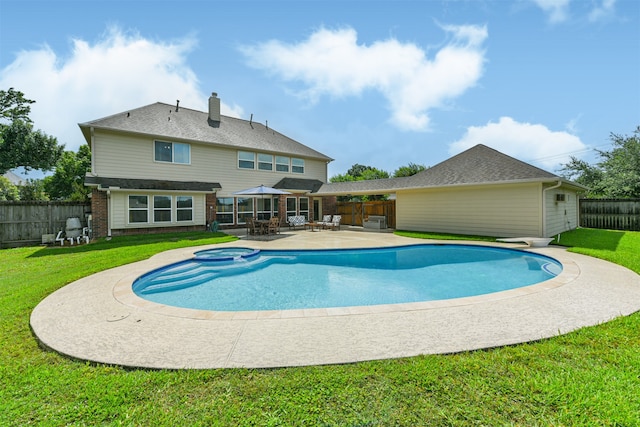 view of swimming pool featuring a patio and a yard