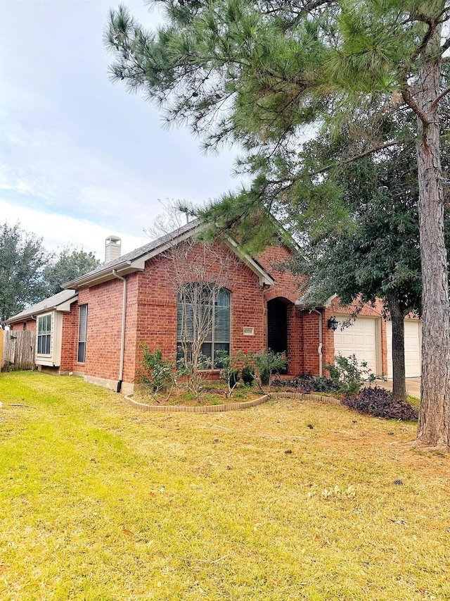 view of front facade with a front lawn and a garage