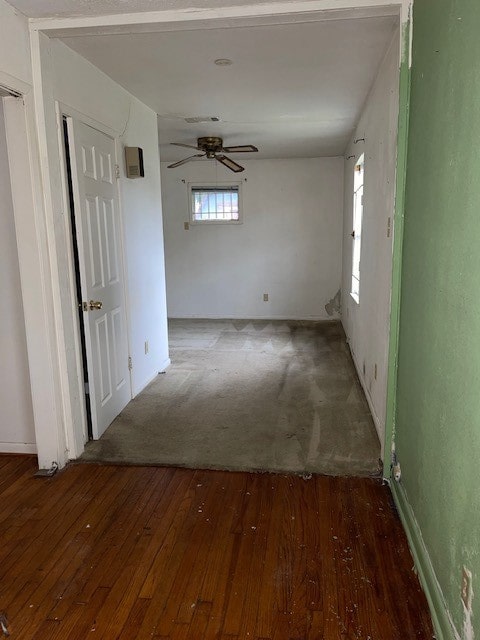 unfurnished room with ceiling fan and dark hardwood / wood-style flooring