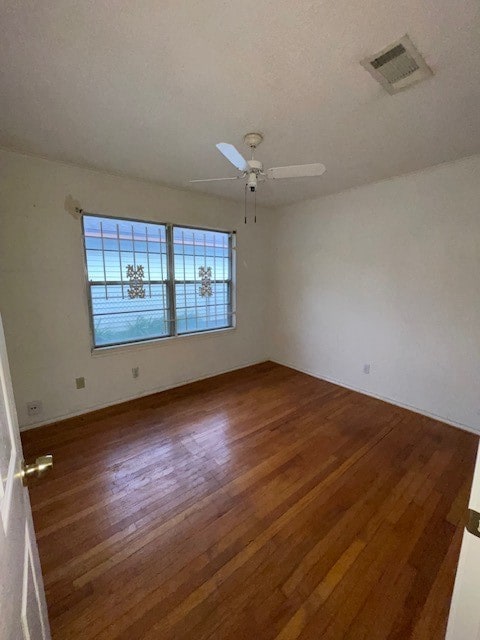 unfurnished room with dark hardwood / wood-style floors and ceiling fan