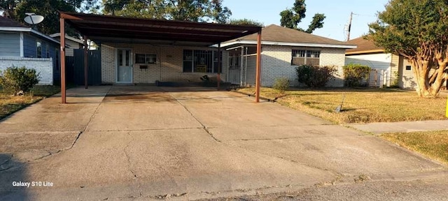 single story home with a carport and a front lawn