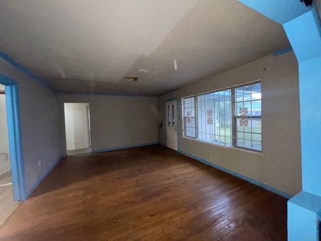 unfurnished room with dark hardwood / wood-style flooring