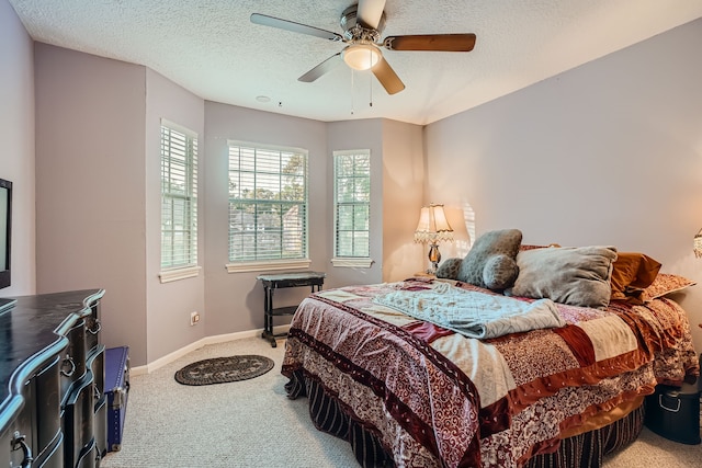 carpeted bedroom with a textured ceiling and ceiling fan