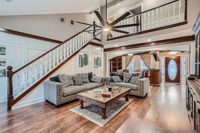 living room featuring ceiling fan, beamed ceiling, dark hardwood / wood-style floors, and high vaulted ceiling