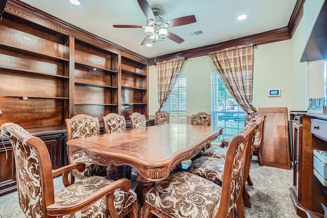 dining room with ornamental molding, ceiling fan, and light colored carpet