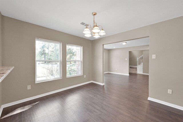 696 Ravensworth Dr, Conroe, TX 77302 - unfurnished dining area with visible vents, stairway, a chandelier, baseboards, and dark wood-style floors
