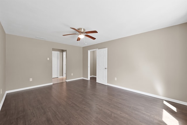 unfurnished room featuring ceiling fan and dark hardwood / wood-style floors