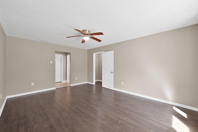 696 Ravensworth Dr, Conroe, TX 77302 - empty room featuring dark wood finished floors, baseboards, a ceiling fan, and visible vents
