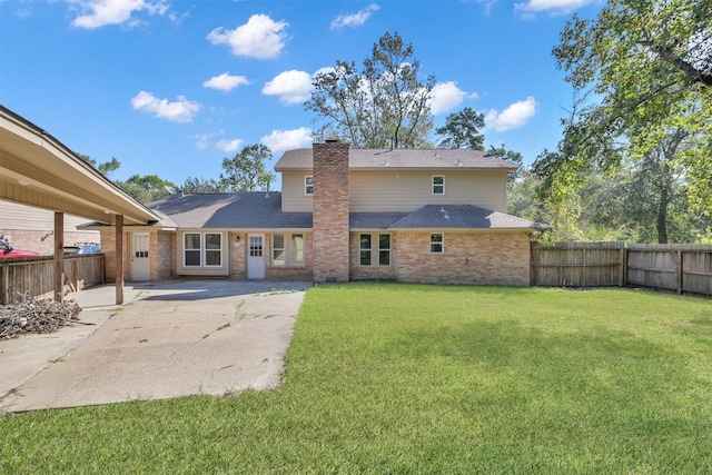 rear view of property featuring a patio and a yard