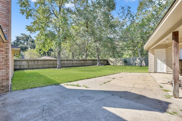 696 Ravensworth Dr, Conroe, TX 77302 - view of yard featuring a patio and a fenced backyard
