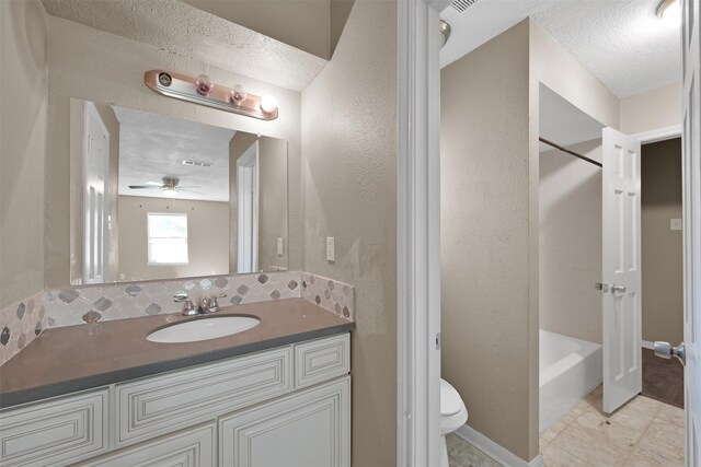 696 Ravensworth Dr, Conroe, TX 77302 - bathroom with tasteful backsplash, vanity, a textured ceiling, and toilet