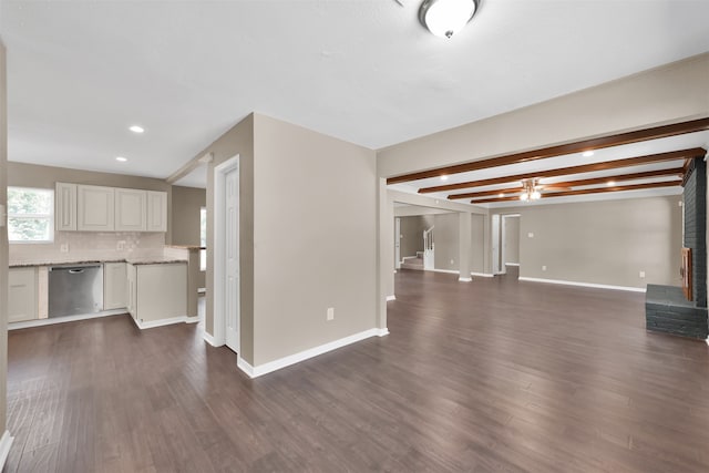 unfurnished living room featuring a brick fireplace, beam ceiling, and dark hardwood / wood-style flooring