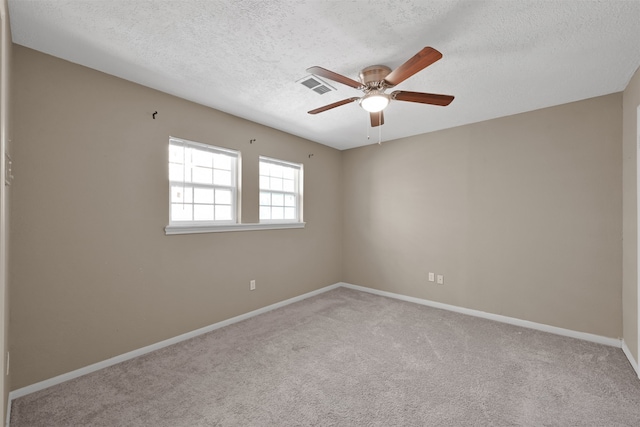 unfurnished room with light carpet, a textured ceiling, and ceiling fan