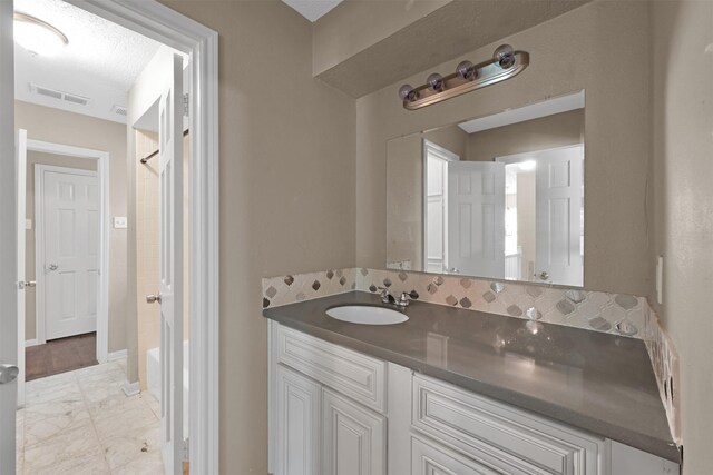696 Ravensworth Dr, Conroe, TX 77302 - bathroom with vanity, baseboards, walk in shower, visible vents, and marble finish floor