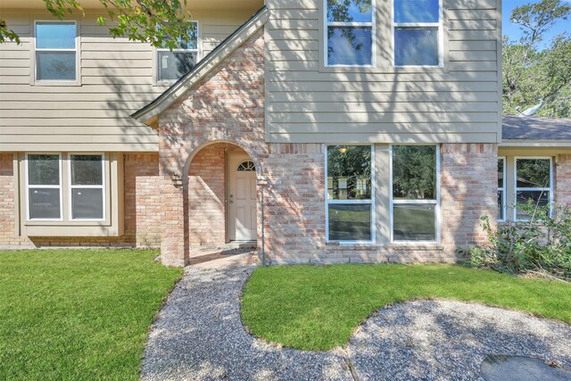 696 Ravensworth Dr, Conroe, TX 77302 - view of front of home with a front yard and brick siding
