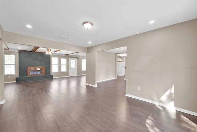 unfurnished living room with a healthy amount of sunlight, ceiling fan, a fireplace, and dark hardwood / wood-style flooring