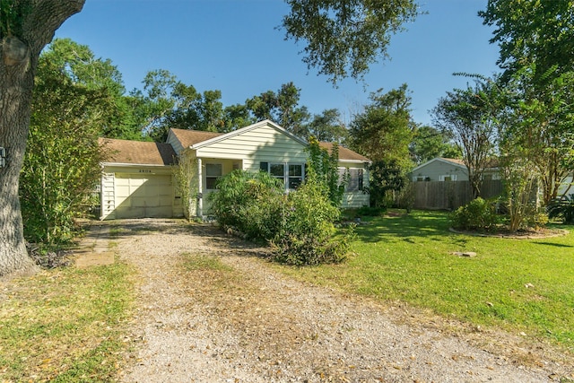 view of front of property with a front yard and a garage