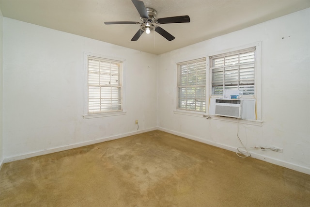 carpeted spare room featuring cooling unit and ceiling fan