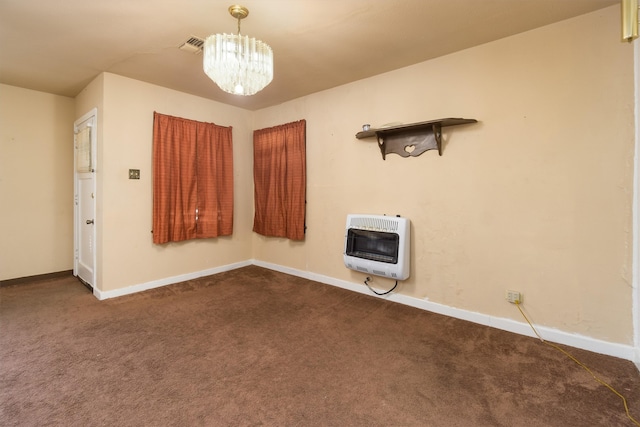 carpeted empty room with heating unit and an inviting chandelier