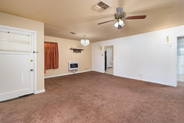 unfurnished living room featuring heating unit, carpet, and ceiling fan