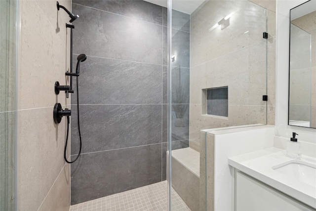 bathroom with vanity and tiled shower