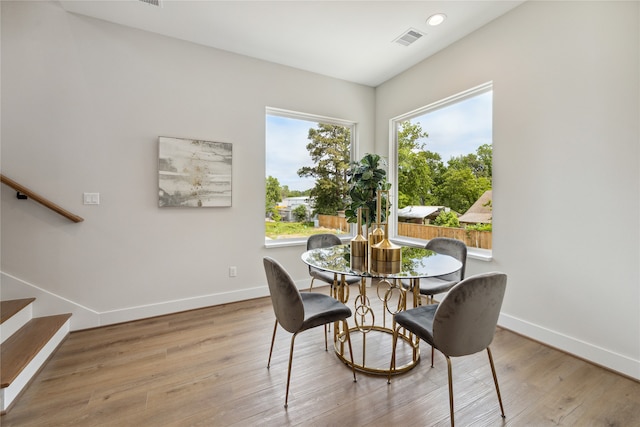 dining space with light hardwood / wood-style floors