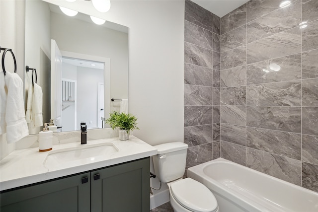 full bathroom featuring vanity, tiled shower / bath combo, and toilet