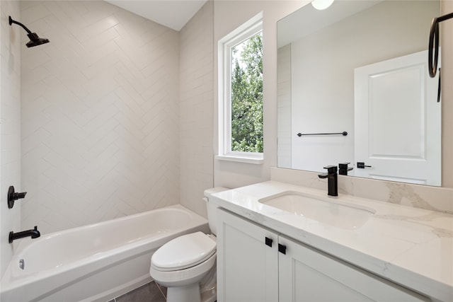 full bathroom with vanity, tiled shower / bath combo, and toilet