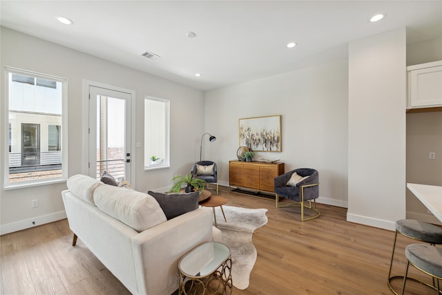 living room with a wealth of natural light and light wood-type flooring