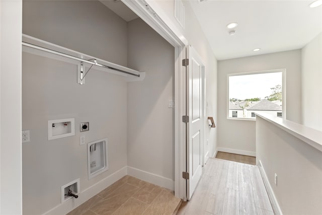 laundry room with light hardwood / wood-style flooring, hookup for an electric dryer, and hookup for a washing machine