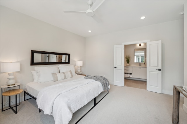 carpeted bedroom featuring ensuite bath and ceiling fan