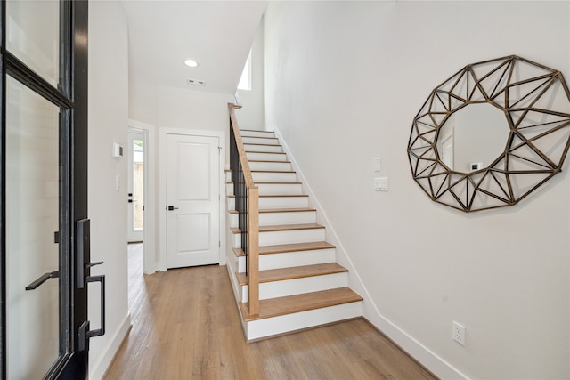 stairway featuring wood-type flooring