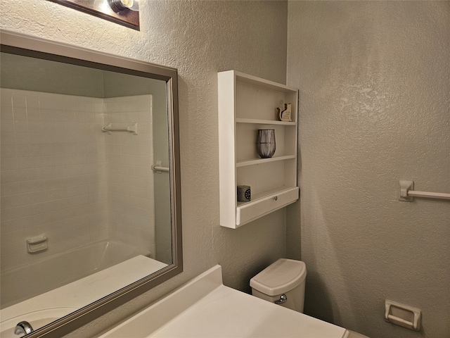 bathroom with tub / shower combination and toilet