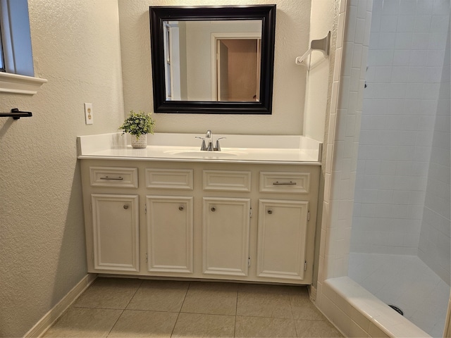 bathroom with walk in shower, vanity, and tile patterned floors