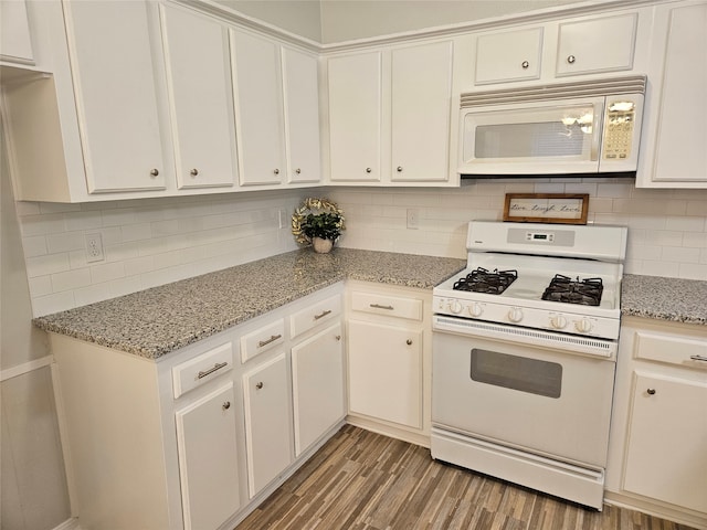 kitchen featuring white cabinetry, decorative backsplash, hardwood / wood-style floors, and white appliances