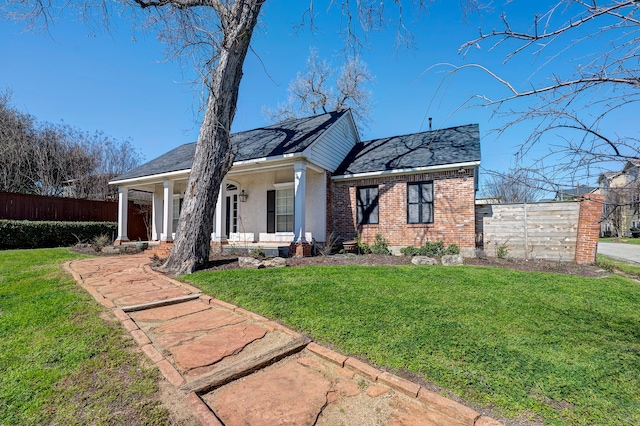 view of front facade with a front yard and a porch