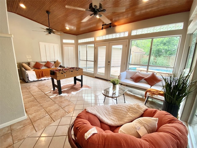 interior space with light tile patterned floors, wooden ceiling, vaulted ceiling, and ceiling fan