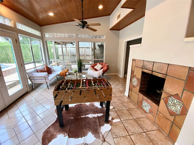 recreation room with wood ceiling, high vaulted ceiling, a wealth of natural light, and ceiling fan