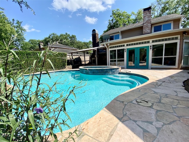 view of swimming pool with an in ground hot tub and a patio